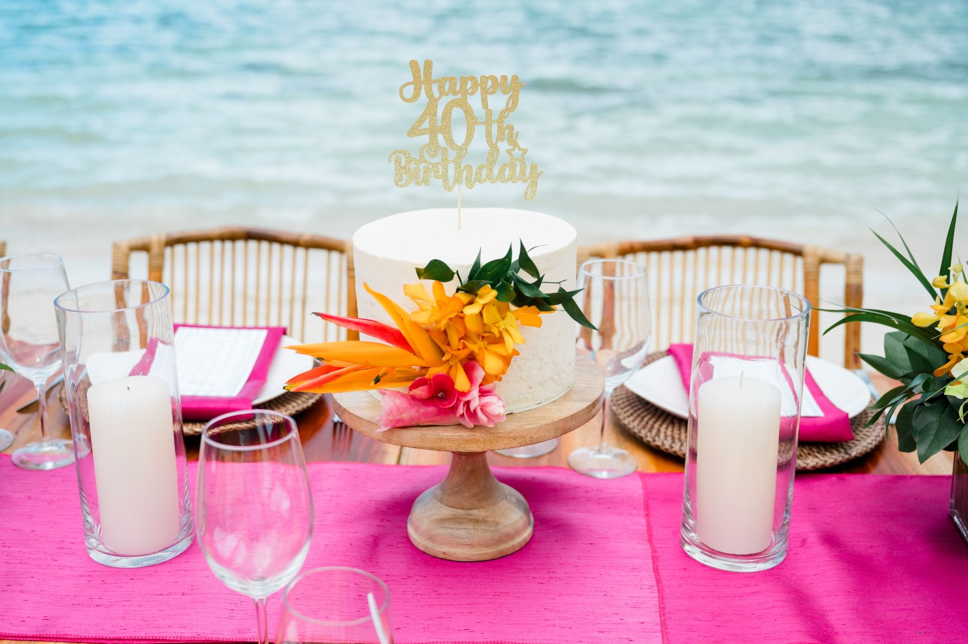 White birthday cake with tropical flowers and “Happy 40th Birthday” topper at Sandals Negril