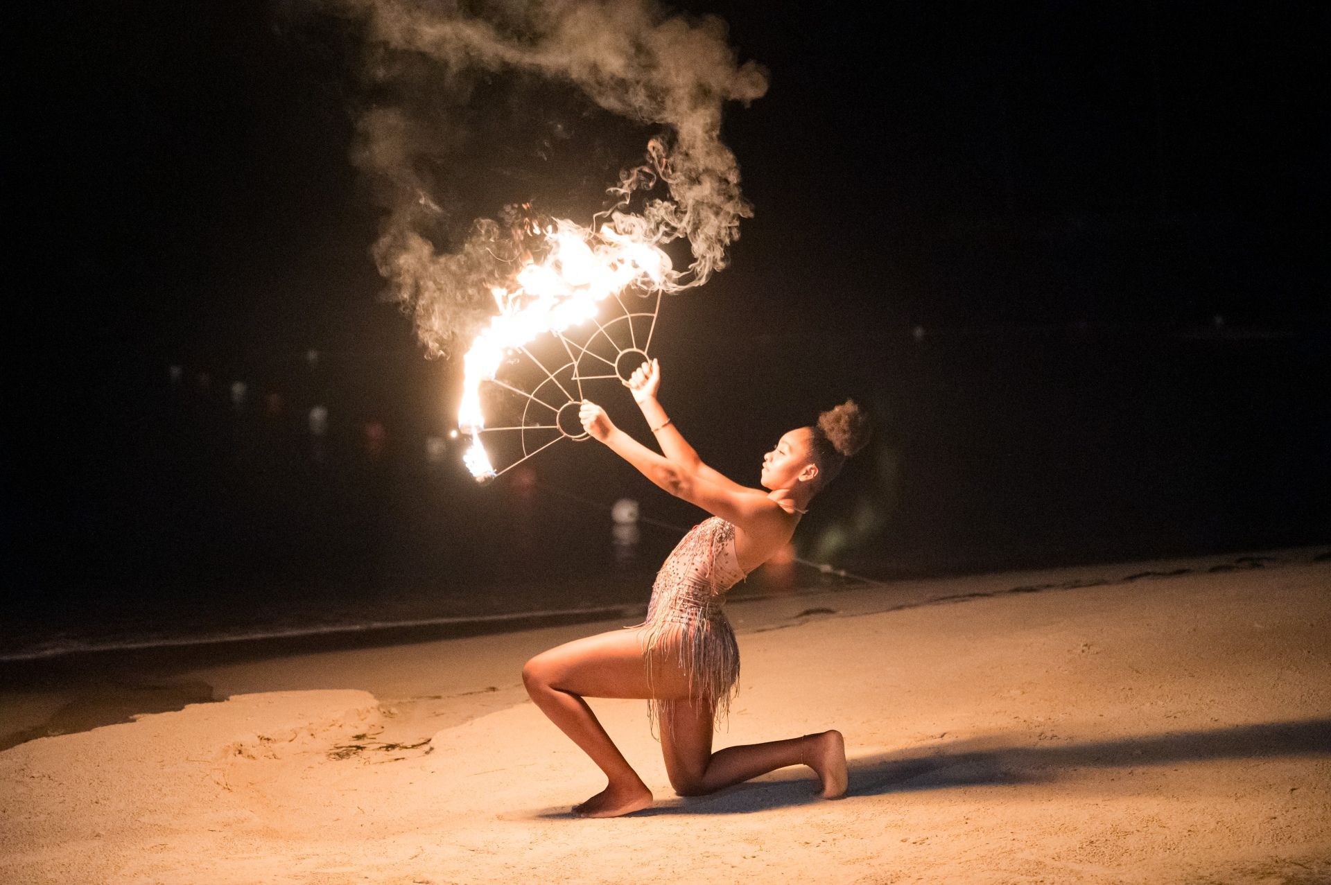 Fire dancer performing on the beach at night at Sandals Negril