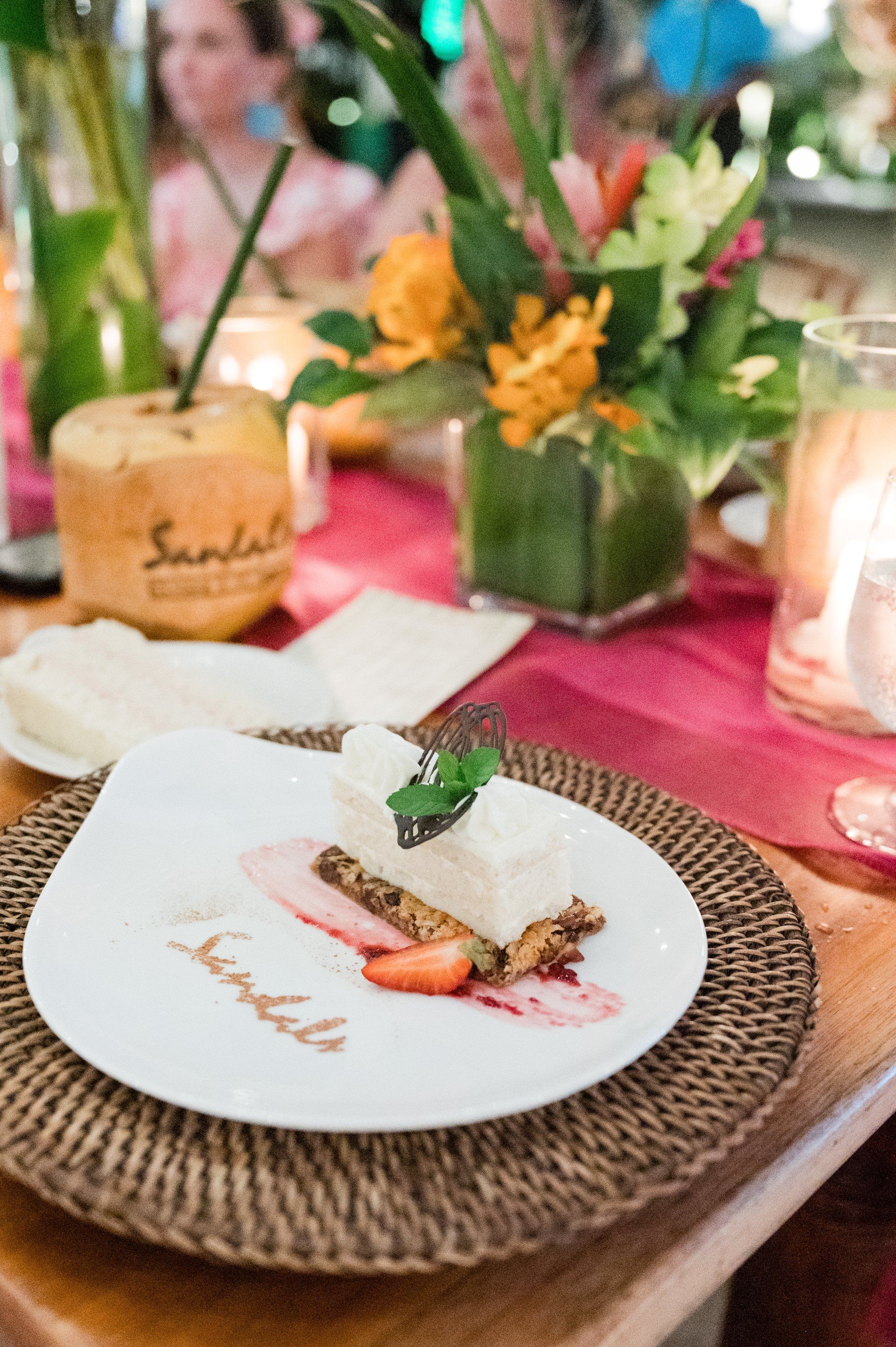 White dessert plate with Sandals logo and strawberry garnish